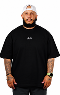 Front view of the black Fortis Oversized Essential T with white chest script.