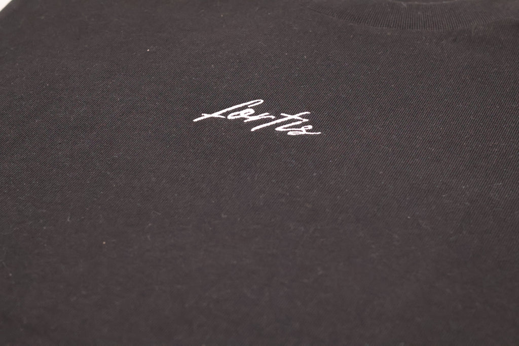 Close-up of the white Fortis script on the black Essential T.