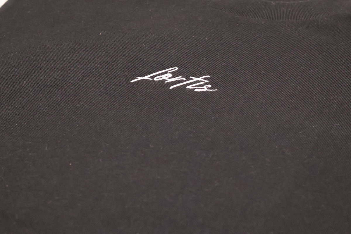 Close-up of the white Fortis script on the black Essential T.